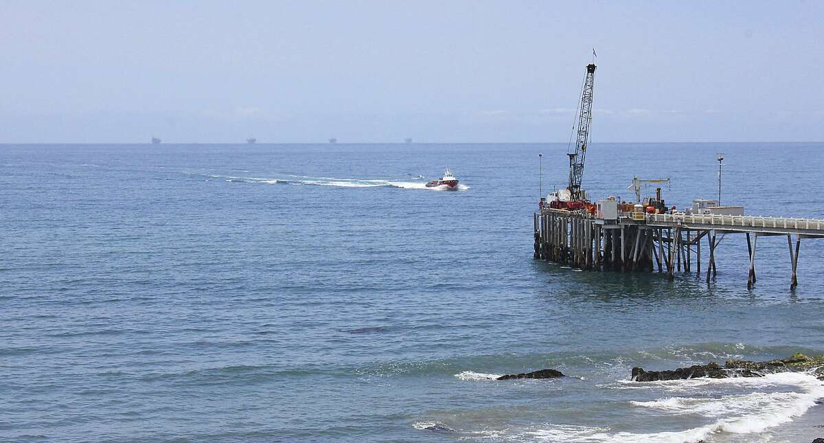 FILE- This May 16, 2015, file photo shows oil drillings offshore of a service pier in the Santa Barbara Channel off the coast of Southern California near Carpinteria. Opposition to the Trump administration’s plan to expand offshore drilling mounted Wednesday, Jan. 10, 2018. The plan could open up federal waters off the California coast for the first time in more than three decades. The Channel is one of those areas that could open up. (AP Photo/John Antczak, File)