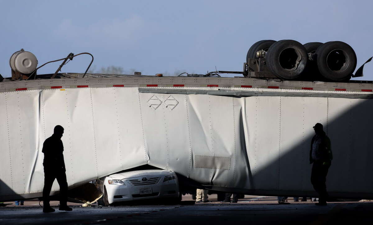 Authorities responded to a scene where an 18-wheeler was overturned on University Boulevard, after it drive off the southbound U.S. 69 Highway Thursday, Jan. 11, 2018, in Sugar Land, Texas.