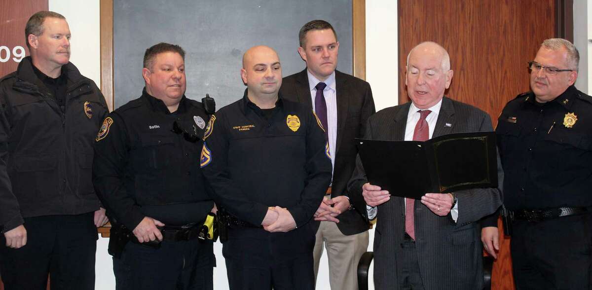 Westport First Selectmen reads a proclamation announcing Jan. 10 “Law Enforcement Appreciation Day” at the Board of Selectmen meeting in Town Hall with members of the police department standing behind him.