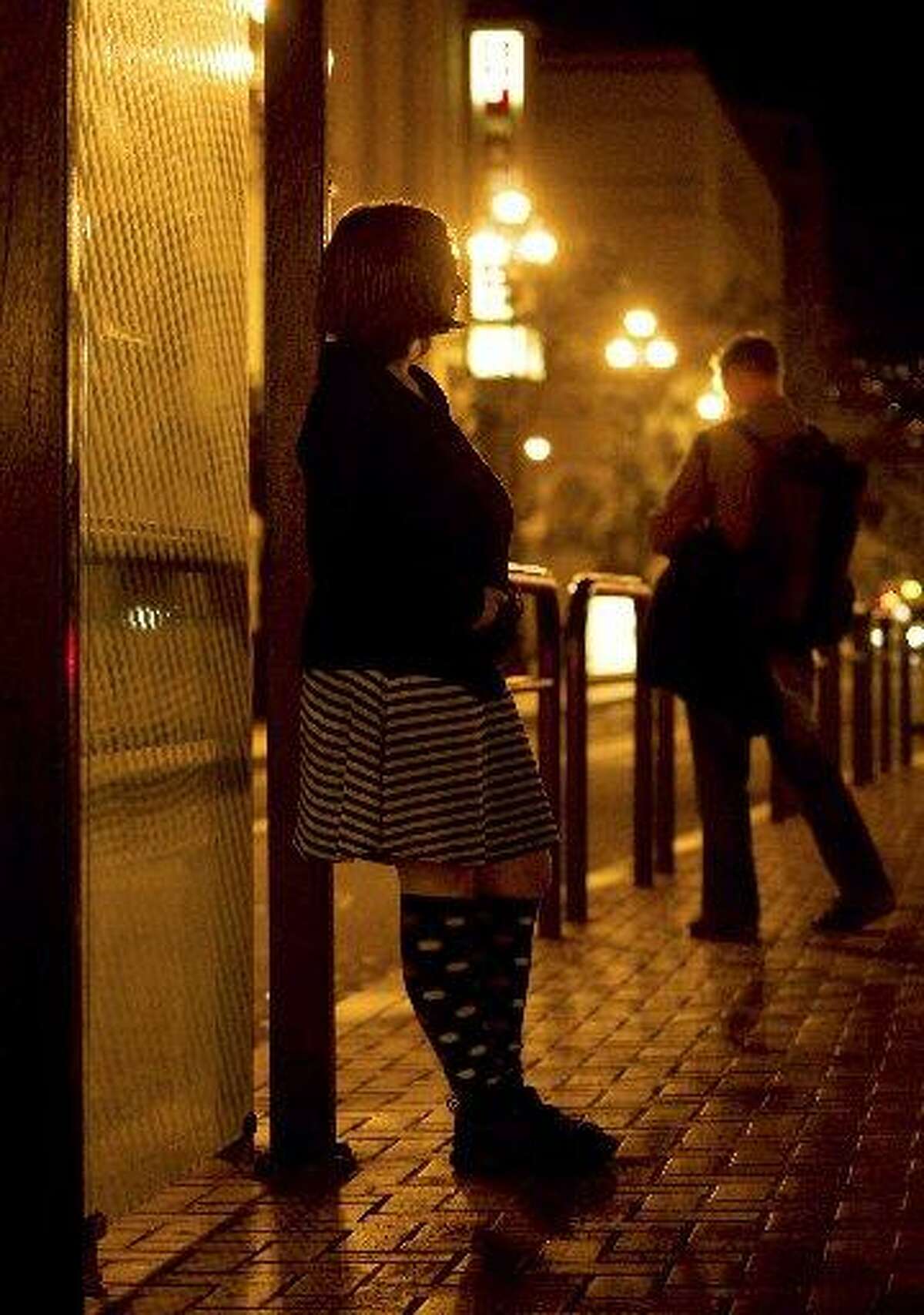 A sex worker who goes by the name “Violet” poses for a picture at a bus stop in downtown San Francisco on Thursday, Oct. 16, 2008. City law enforcement officials on Thursday said they will no longer arrest or charge sex workers for prostitution or petty drug crimes if they are victims or witnesses to violent crime.