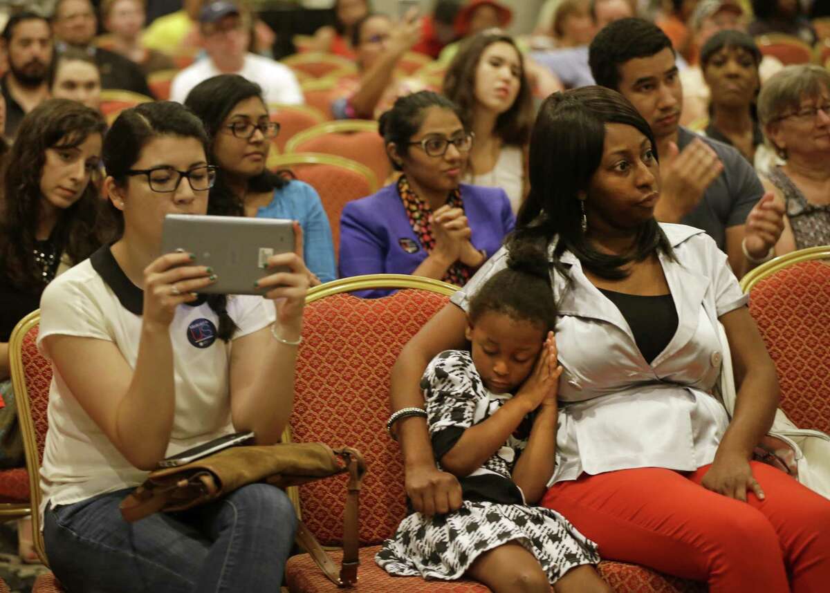 Artrinity Neal, 4, rests on the shoulder of her mother, Artrina Neal, during a public forum on Medicaid held by Congressman Al Green along with the Children's Defense Fund-Texas and others in Houston in 2017. A bill offers some help in allowing children in need to remain in Medicaid for one-year stints without renewal.