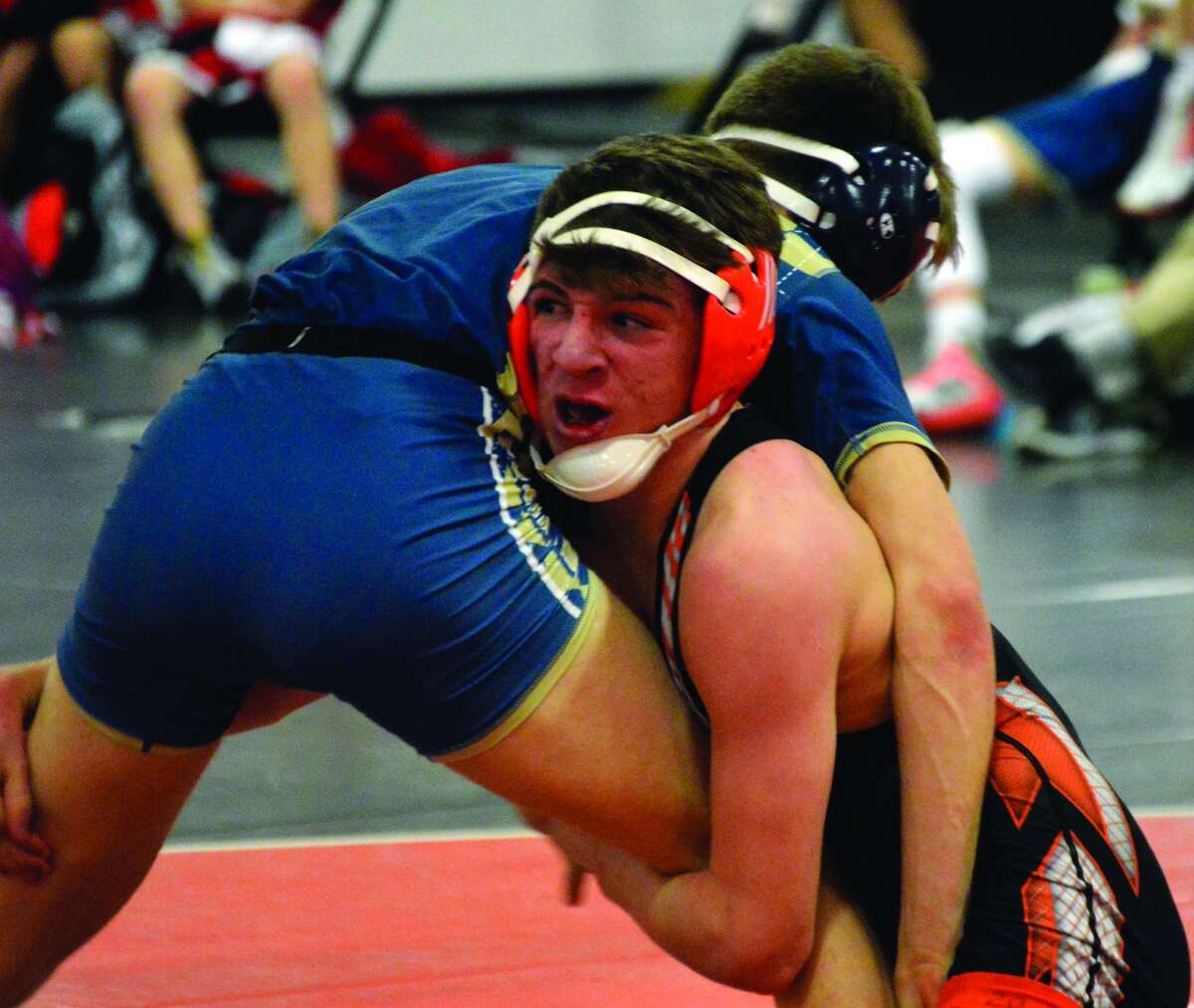 Edwardsville’s Dylan Wright, right, battles Althoff’s Max Kristoff at 138 pounds.