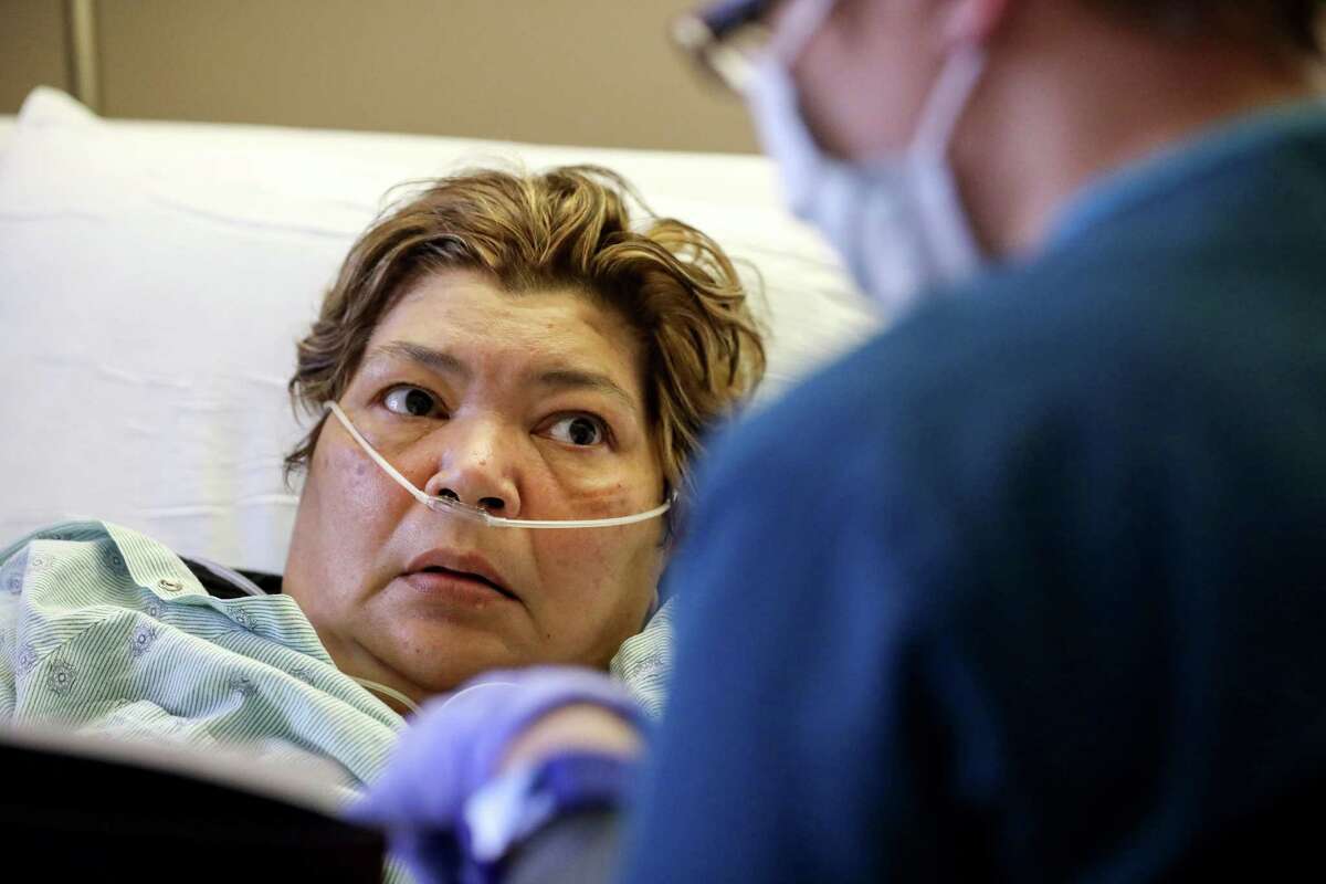 Sara Jimenez, left, a flu patient, talks about her care with Jennifer Brown, a nurse, at Houston Methodist Hospital, Thursday, Jan. 11, 2018, in Houston. "It wasn't a light flu," she said. "It was something real bad."