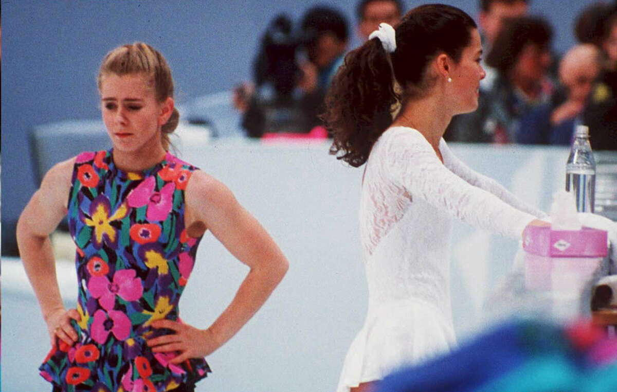 US figure skaters Tonya Harding (L) and Nancy Kerrigan avoid each other during a training session 17 February in Hamar, Norway, during the Winter Olympics. Kerrigan was hit on the knee in January 1994 during the US Olympic Trials and it was later learned that Harding's ex-husband and bodyguard masterminded the attack in hopes of improving Harding's chances at the US Trials and the Olympics. (COLOR KEY: Harding has yellow) (Photo credit should read VINCENT AMALVY/AFP/Getty Images)