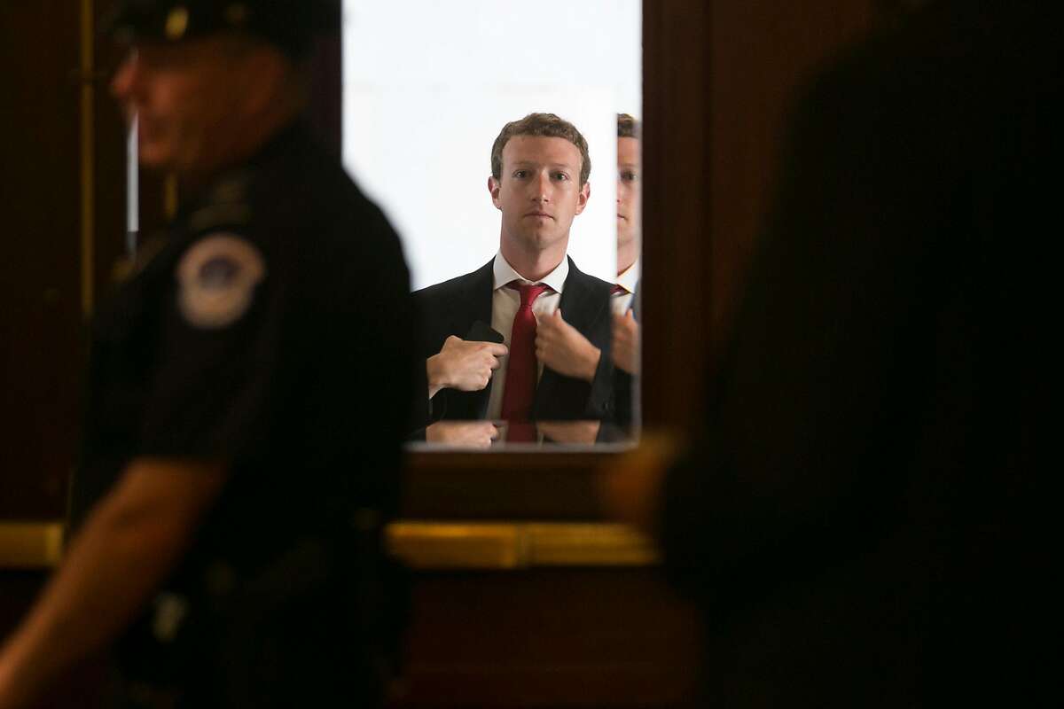 Mark Zuckerberg, founder and chief executive officer of Facebook Inc., adjusts his jacket while arriving at the U.S. Capitol in Washington, D.C., U.S., on Thursday, Sept. 19, 2013.