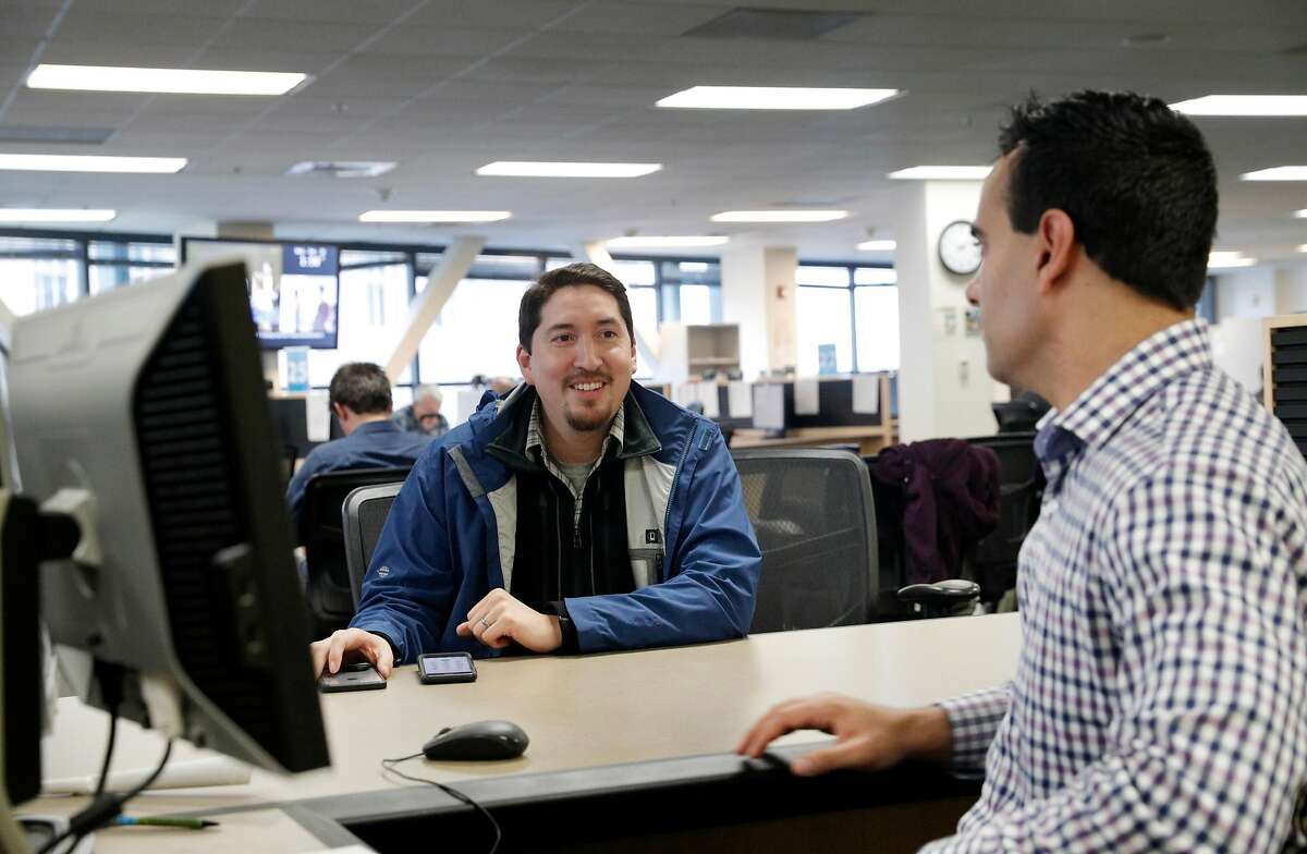 Gustav Choto, left, talks with Omar Masry, the Senior Analyst at the Office of Short Term Rentals in San Francisco, Calif., on Wednesday, January 10, 2018. San Francisco residents who wish to host guests host guests through Airbnb, VRBO or other homesharing services must register with SF by Jan. 16 or they will be penalized by the city.