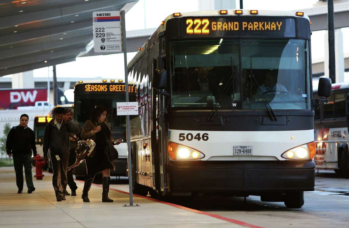 Morning commuters board a Metro bus at the Grand Parkway Park and Ride on Dec. 20.