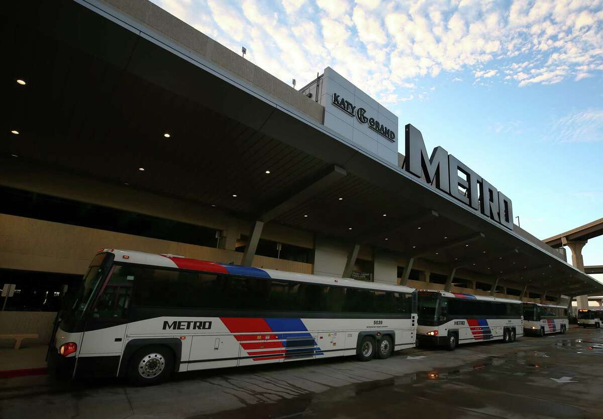Morning commuters board Metro buses at the Grand Parkway Park and Ride on Dec. 20.