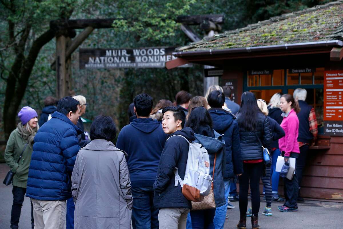 Visitors will pay to park at Muir Woods starting Tuesday, when the National Park Service begins requiring reservations at lots and on shuttle buses.