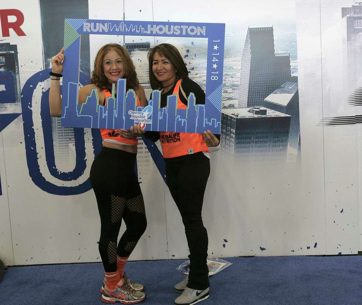 Blanca Villarreal, left, and Erika Clemente pose for a photo in the expo for the 2018 Chevron Houston Marathon and Aramco Houston Half Marathon at George R. Brown Convention Center on Friday, Jan. 12, 2018, in Houston. ( Elizabeth Conley / Houston Chronicle )