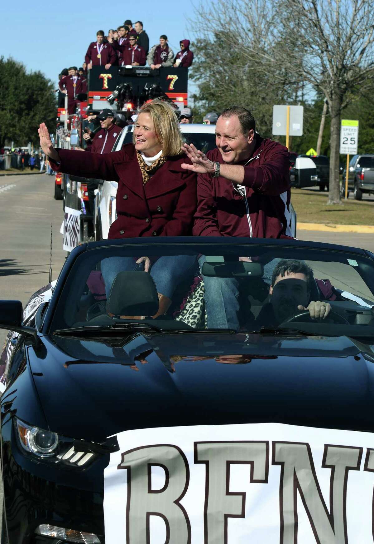 Cy-Fair High School head football coach Ed Pustejovsky, right, and his wife Marianne, a CFHS science teacher, wave to their fans whiole riding as the grand marshals of the school's football parade on January 12, 2018. (Photo by Jerry Baker/Freelance)