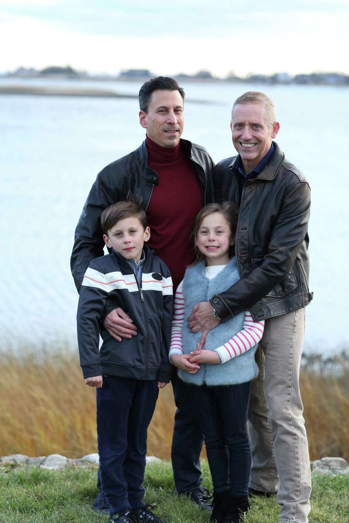 Mark Ciano and Chris Buckley pose for a family portrait with their twin children, Connor and Ayla Ciano-Buckley.