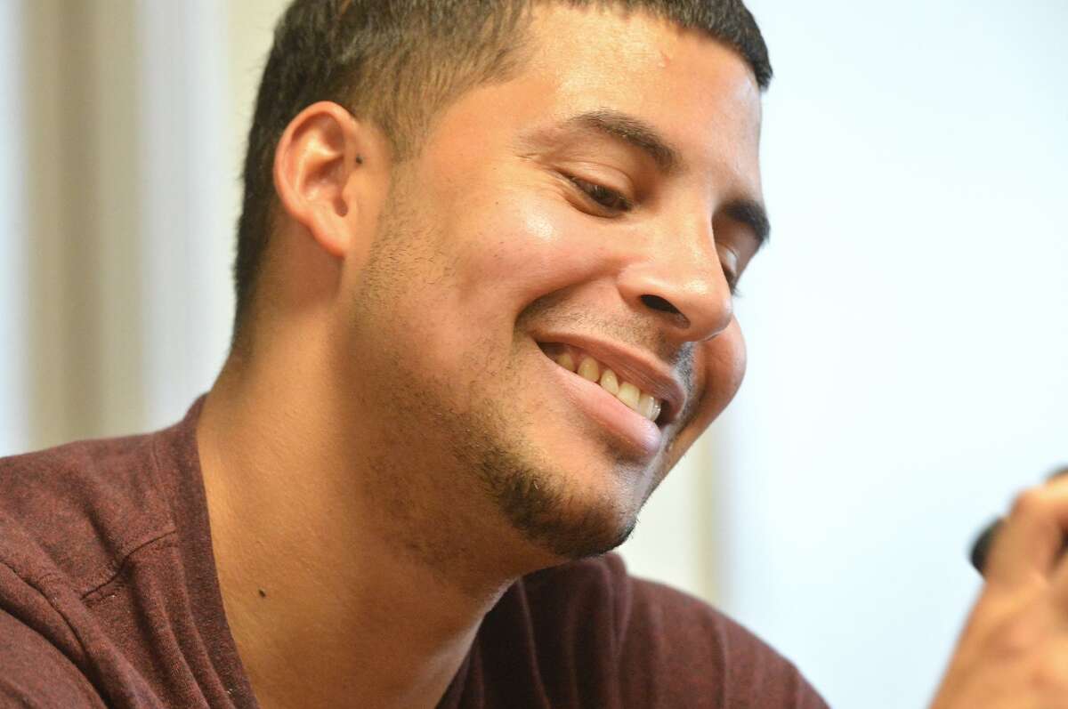 Hector Alicea smiles while talking about how his life has changed for the better while visiting at the Open Door Shelter on Merritt Street Hector was a resident here at 8 years old when he and his family were homeless in Norwalk.