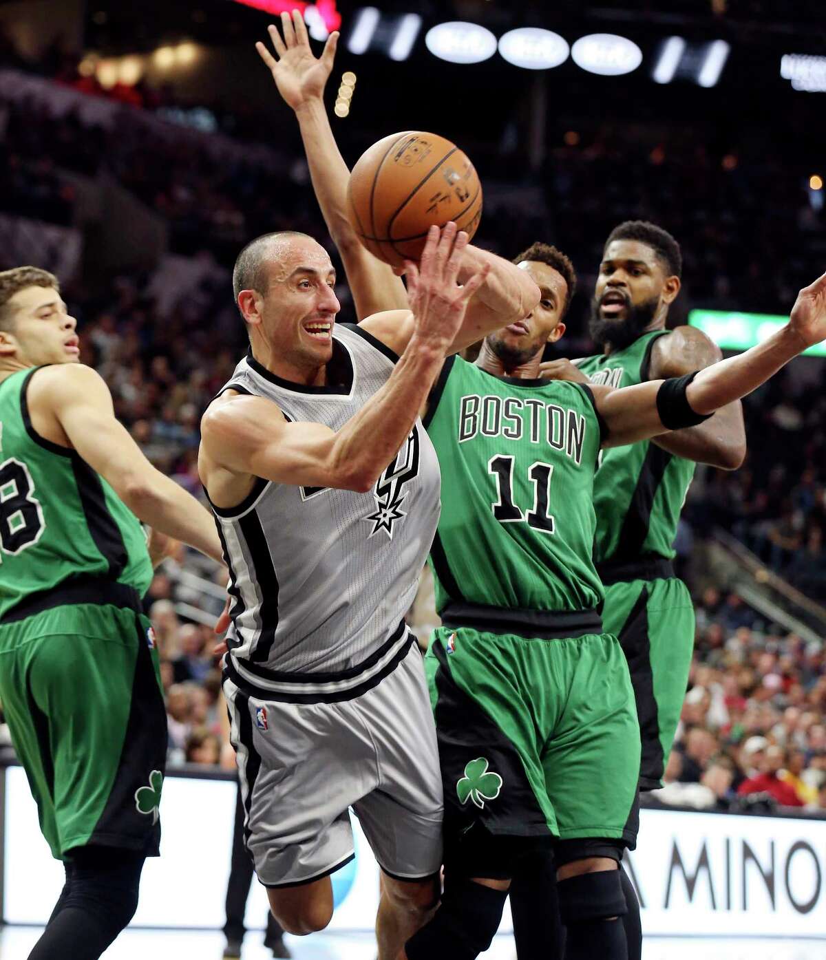San Antonio Spurs' Manu Ginobili pass between Boston Celtics' R.J. Hunter (left) and Evan Turner during second half action Saturday Dec. 5, 2015 at the AT&T Center. The Spurs won 108-105.