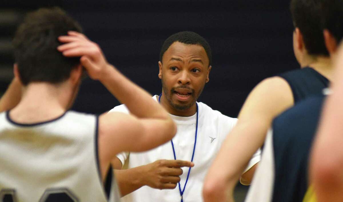 Weston boys basketball coach Jamaal Gibbs, center, talks to his team at the end of practice last week in Weston.