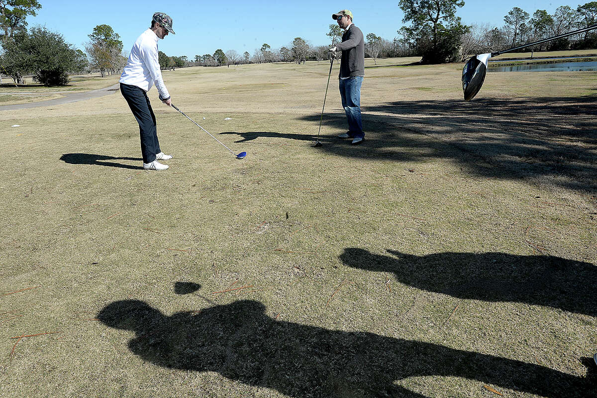 Will Celli looks on as fellow golfer Keith Montalbano practices his position to tee off during the Jay Bruce Golf Benefit Saturday at Bayou Din Golf Club in Beaumont. The annual event hosted by West Brook graduate and MLB player Bruce benefits children and adults with intellectual and developmental disabilities. Photo taken Saturday, January 13, 2018 Kim Brent/The Enterprise
