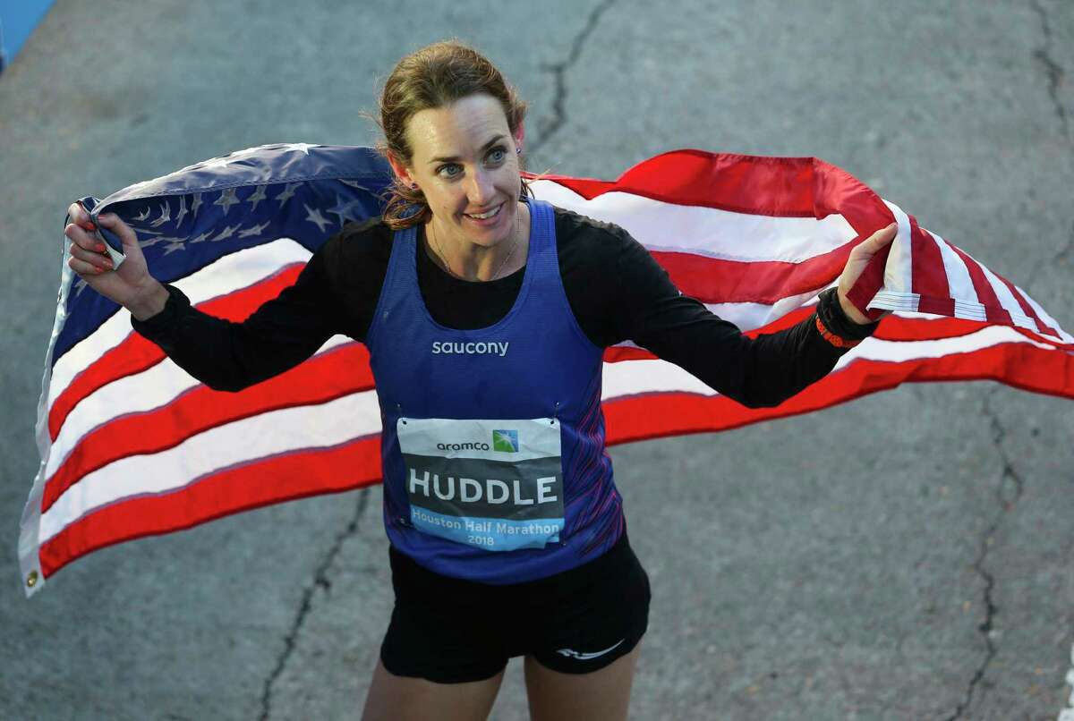 American runner Molly Huddle bears the American flag at the Aramco Half Marathon on Sunday, Jan. 14, 2018, in Houston. Huddle broke the U.S. women's half-marathon record with a record in 1:07:26.