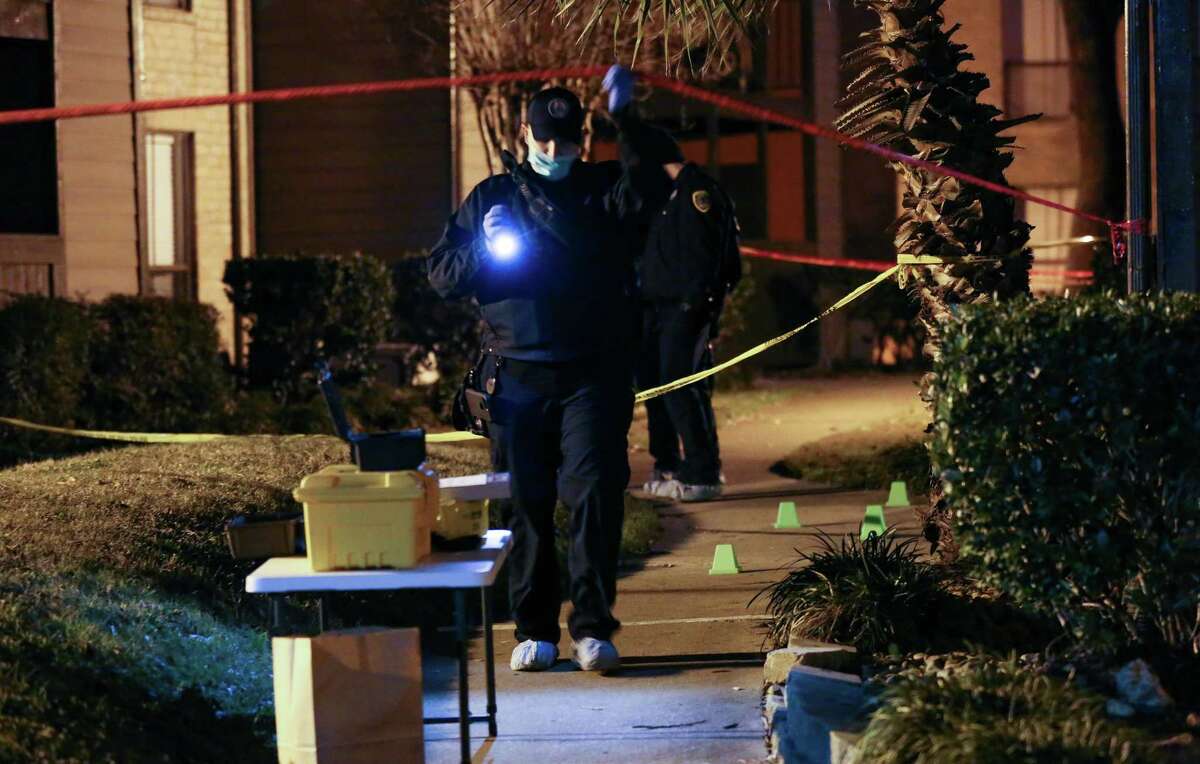 Houston Police officers investigate the scene where a man was stabbed to death at The Hudson Apartment Homes complex Monday, Jan. 15, 2018, in Houston.