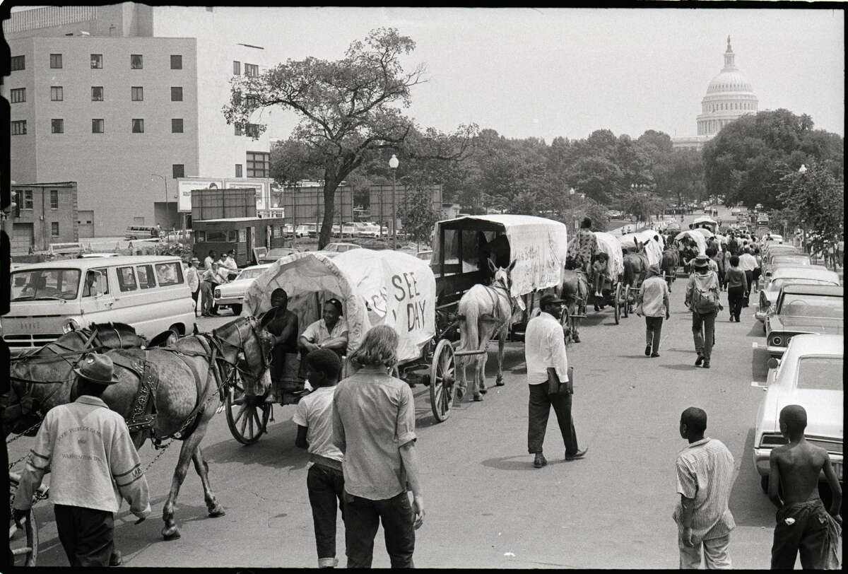(Original Caption) 6/27/1968-Washington, D.C.: The mule train that was a symbol of the Poor People's Campaign heads toward the Capitol after finally crossing the river into Washington June 25th. The mules had been kept across the river from the city during the "Resurrection City" phase of the demonstration. The government impounded the animals June 26, after police said the 24 mules were not being properly cared for and would be turned over to the Humane Society unless demonstration leaders could provide pasture for them.