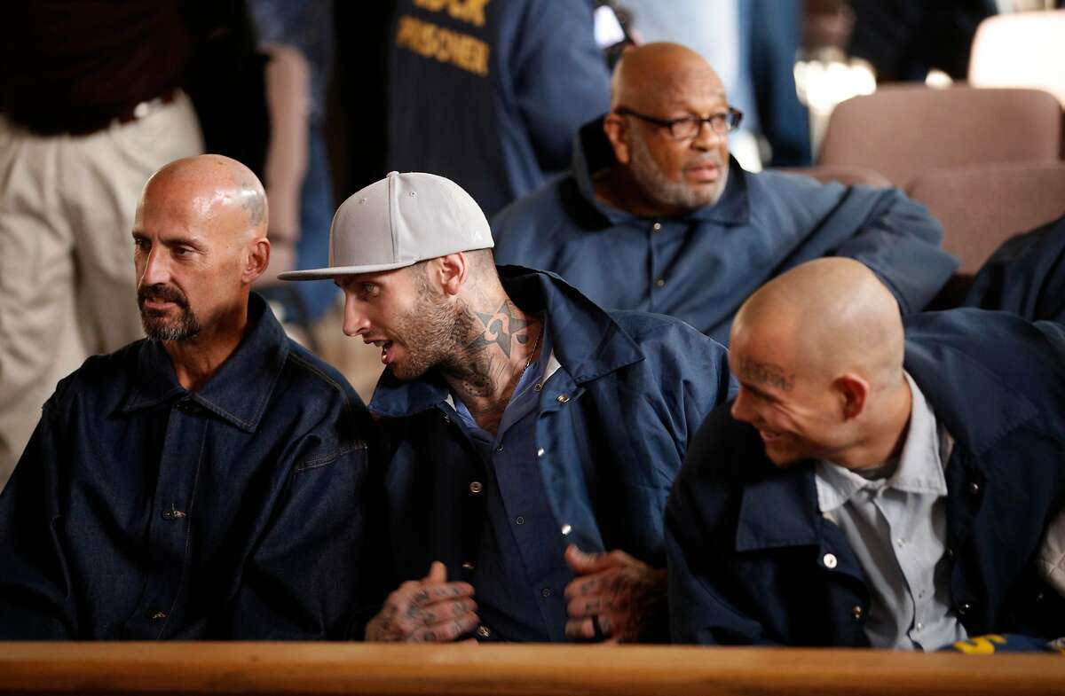 Inmate Branden Riddle-Terrell, (center), one of the subjects of the film, with Tommy Wickerd, (left) and Brian Dietz as they get set for the screening of "Through the Darkness" a documentary about the baseball program, at San Quentin Prison in San Rafael, Calif., on Tues. January 9, 2018.