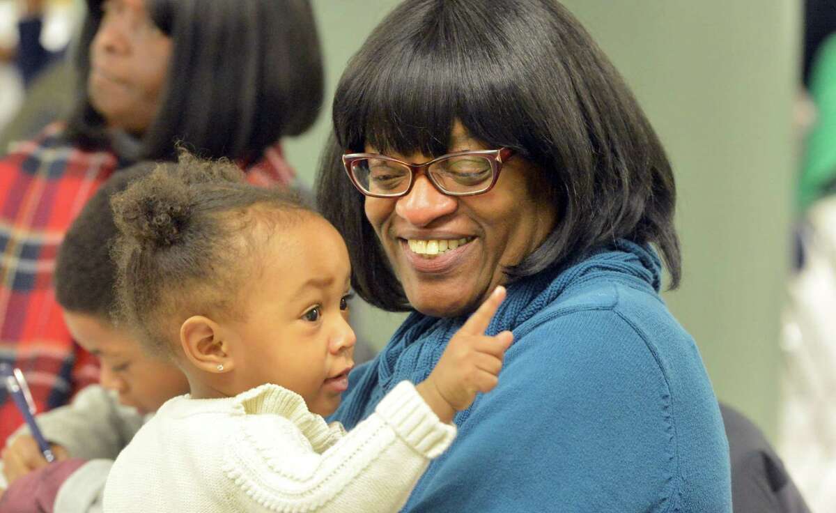 Presley Brown in the arms of her great aunt Mary Mann at the Community Breakfast in observance of Rev. Dr. Martin Luther King, Jr. at West Rocks School on Monday January 15, 2018 in Norwalk Conn.
