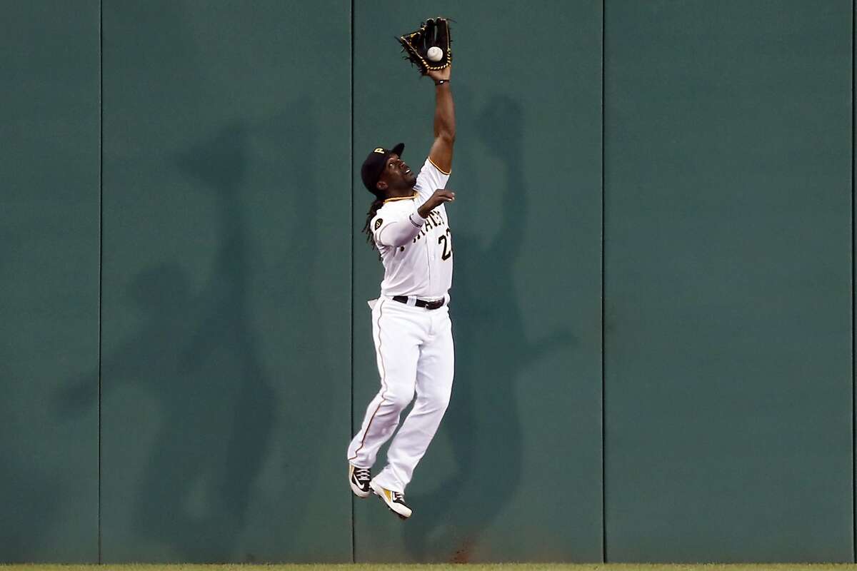 Pittsburgh Pirates center fielder Andrew McCutchen leaps to catch a fly ball by St. Louis Cardinals' Matt Carpenter in the third inning of the baseball game on Tuesday, Aug. 26, 2014, in Pittsburgh. (AP Photo/Keith Srakocic)
