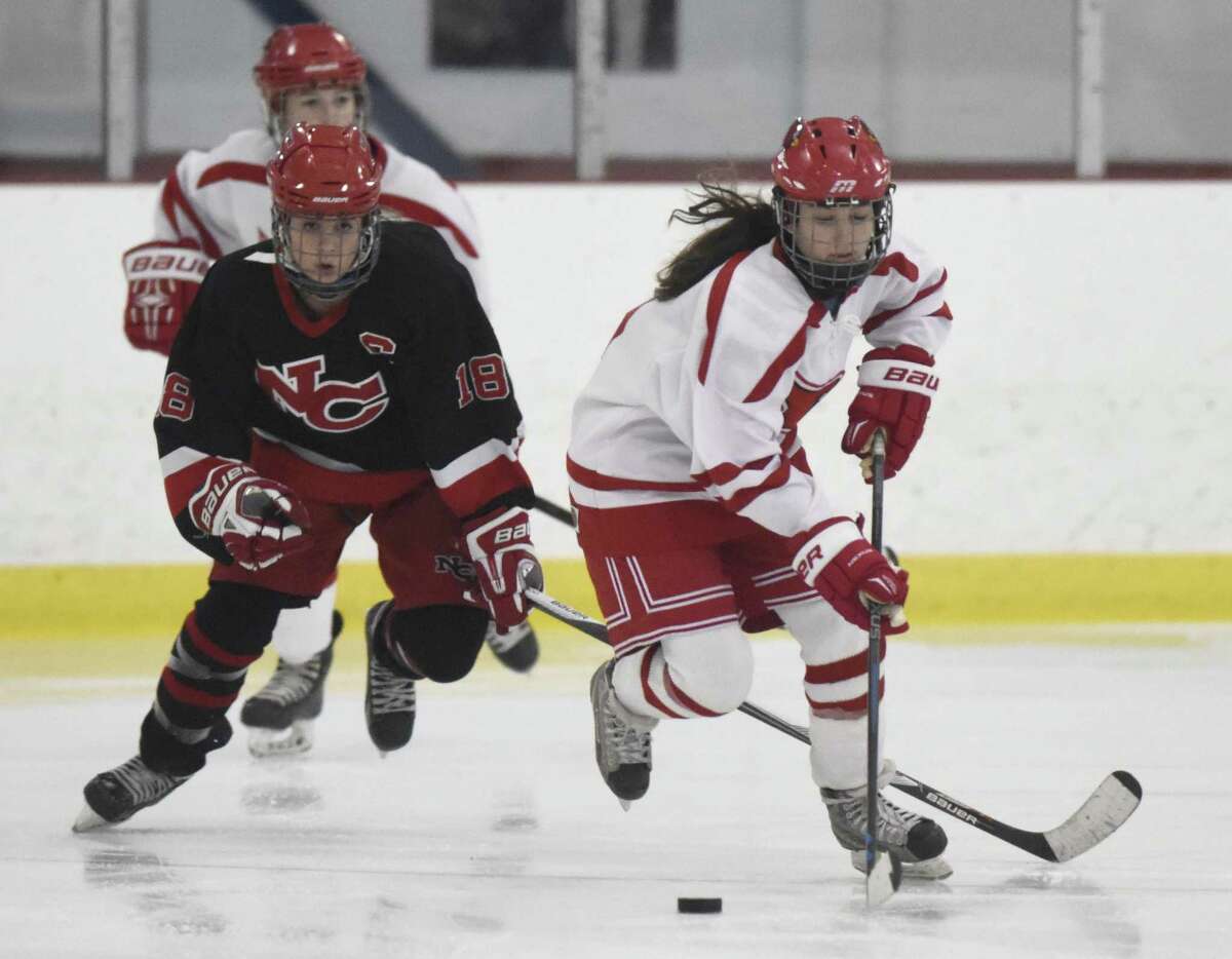Greenwich’s Paige Finneran, right, skates past New Canaan’s Brooke Deane in Greenwich’s 4-1 win over New Canaan in the high school girls hockey game at Dorothy Hamill Skating Rink in Greenwich on Monday.