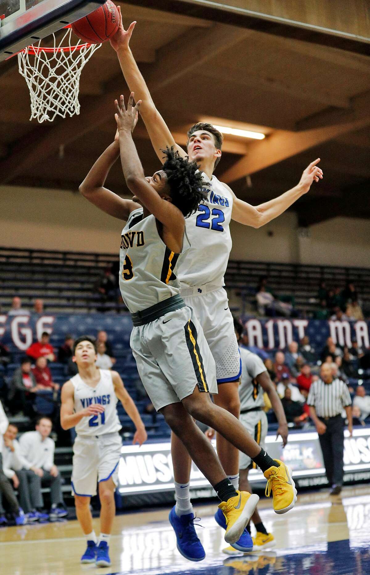 Matt Van Komen (22) blocks a shot by Brendan Patrick (3) in the first half as the Bishop O'Dowd Dragons played the Pleasant Grove (Utah) Vikings at the Martin Luther King, Jr. Classic at St. Mary's College in Moraga, Calif., on Monday, January 15, 2018.