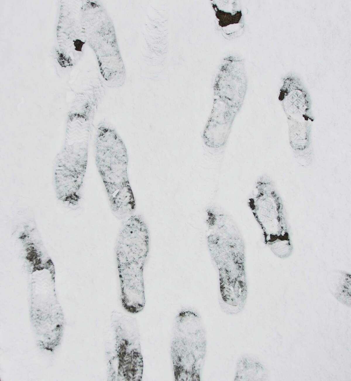 Footprints are seen in the snow at Carl Barton Jr. Park, Friday, Dec. 8, 2017, in Conroe.