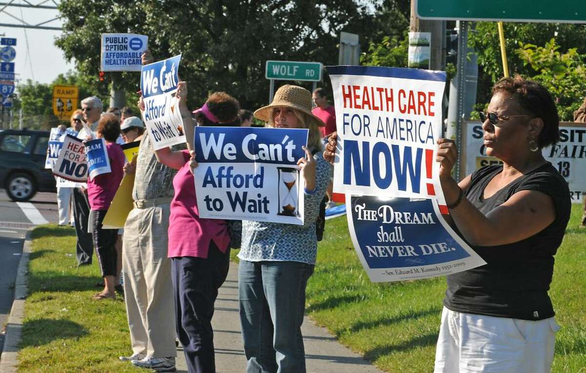 Supporters of health care reform rally Wednesday at the corner of Central Avenue and Wolf Road in Colonie as part of a national event sponsored by MoveOn.org. Other groups participating are the Center for Community Change, Democracy for America, Doctors for America, Health Care for American Now, and TrueMajority. The groups are urging House members, including Scott Murphy, D-Glens Falls, to support a strong public health insurance option they say will help lower skyrocketing health care costs and expand coverage to millions of Americans. (Lori Van Buren /Times Union)