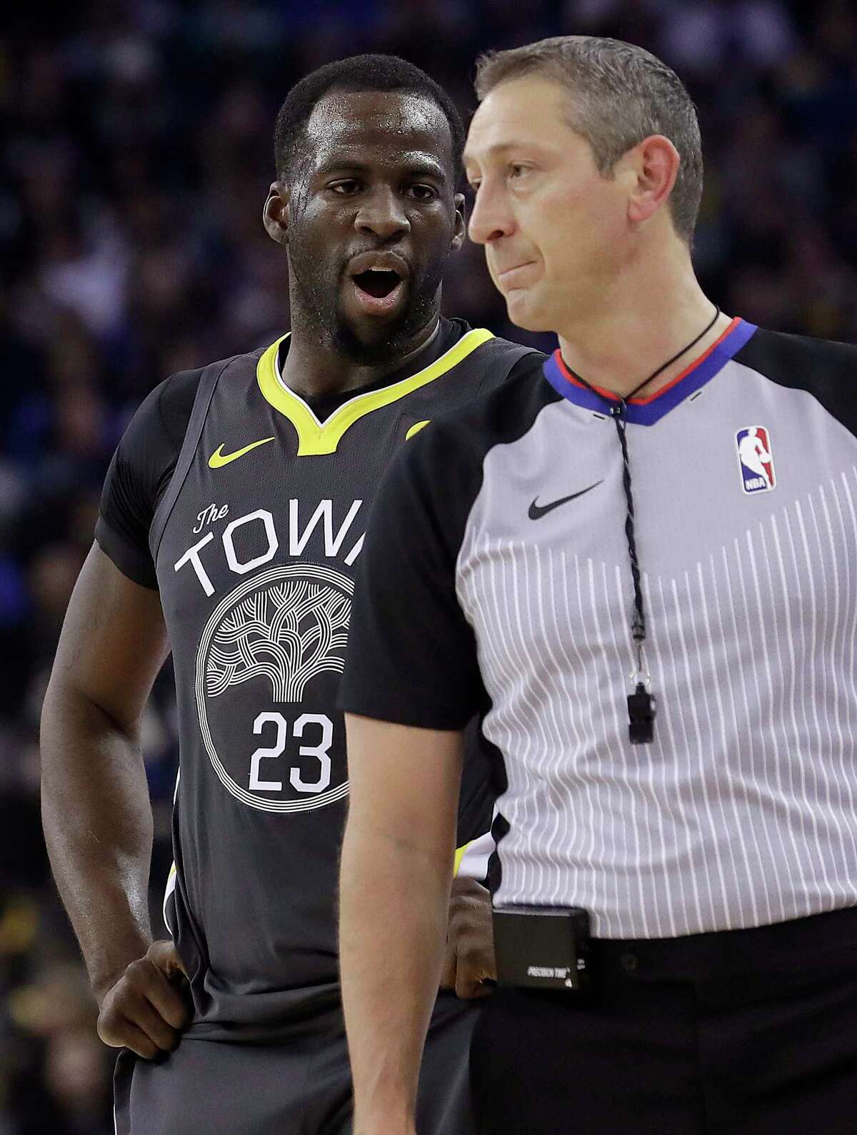 Golden State Warriors forward Draymond Green (23) questions referee J.T. Orr (72) after being called for a foul during the first half of the team's NBA basketball game against the Denver Nuggets in Oakland, Calif., Saturday, Dec. 23, 2017. (AP Photo/Jeff Chiu)