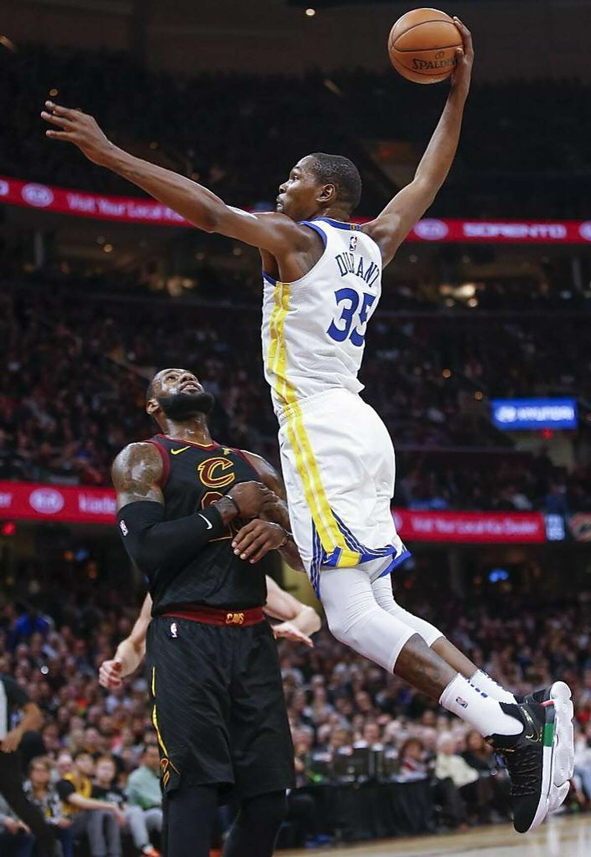 Kevin Durant of the Golden State Warriors goes up for the dunk over LeBron James #23 of the Cleveland Cavaliers at Quicken Loans Arena on January 15, 2018 in Cleveland, Ohio. 