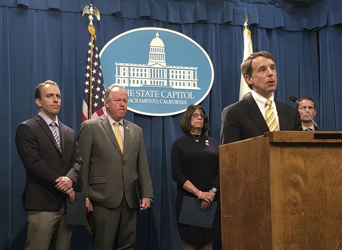 California Insurance Commissioner Dave Jones speaks to reporters while lawmakers listen during a news conference at the state Capitol in Sacramento, Calif., Tuesday, Jan. 16, 2018. Jones and the lawmakers are introducing a variety of bills to protect consumers who lose their homes in major disasters, a response to complaints about insurance companies from people who lost their homes in last year's destructive wildfires. (AP Photo/Jonathan J. Cooper)