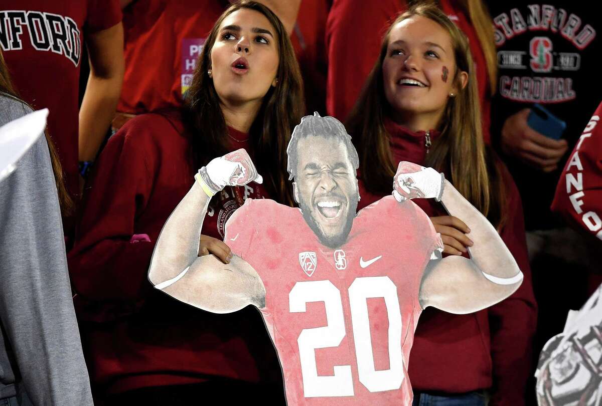 Stanford Cardinal fans in the stands holds up a cardboard cutout of Stanford running back Bryce Love #20 during an NCAA game against the Oregon Ducks at Stanford Stadium on October 14, 2017 in Palo Alto, California.