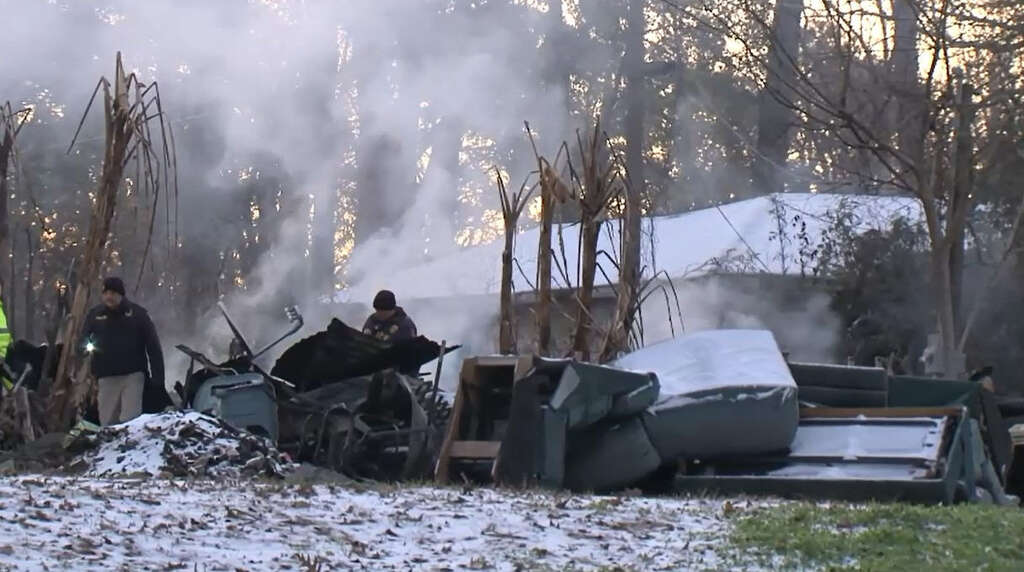 Officials surround a burned mobile home fire off of Cherry Laurel Street in Huffman, Texas on Jan. 17, 2018. A mother and her two children died in the blaze, Harris County Sheriff Ed Gonzales said. Photo: Metro Video