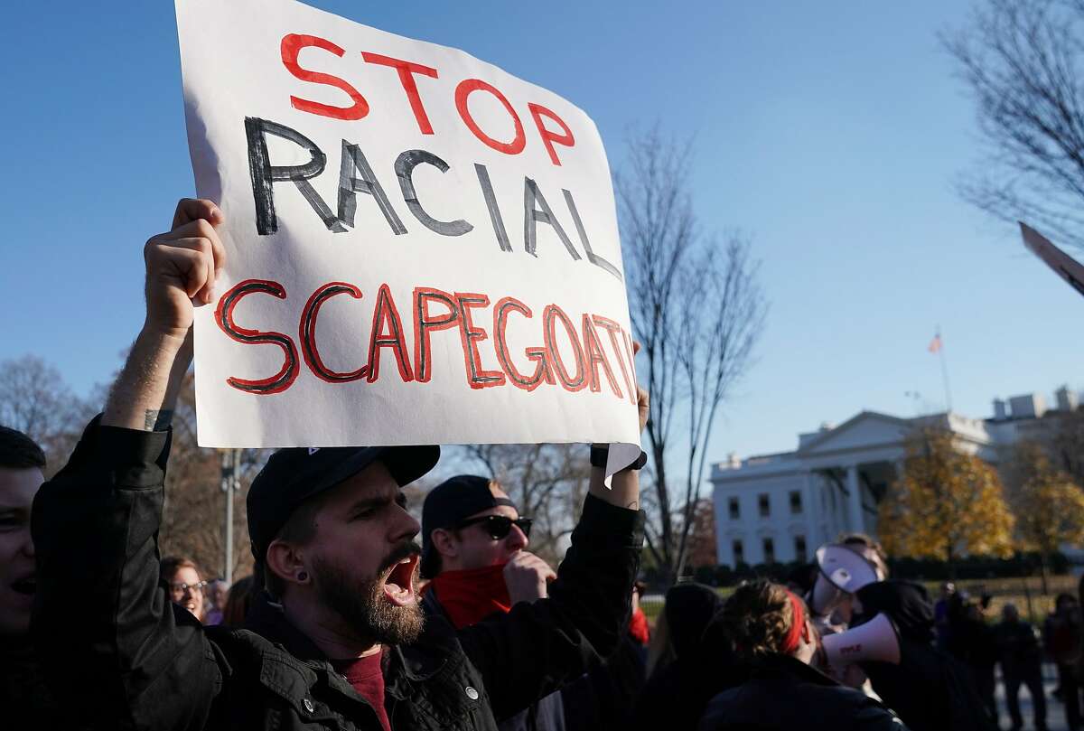 This file photo taken on December 3, 2017 shows counter-protesters shouting slogans at white nationalists during an anti-immigration rally front of the White House on Pennsylvania Avenue in Washington, DC. 