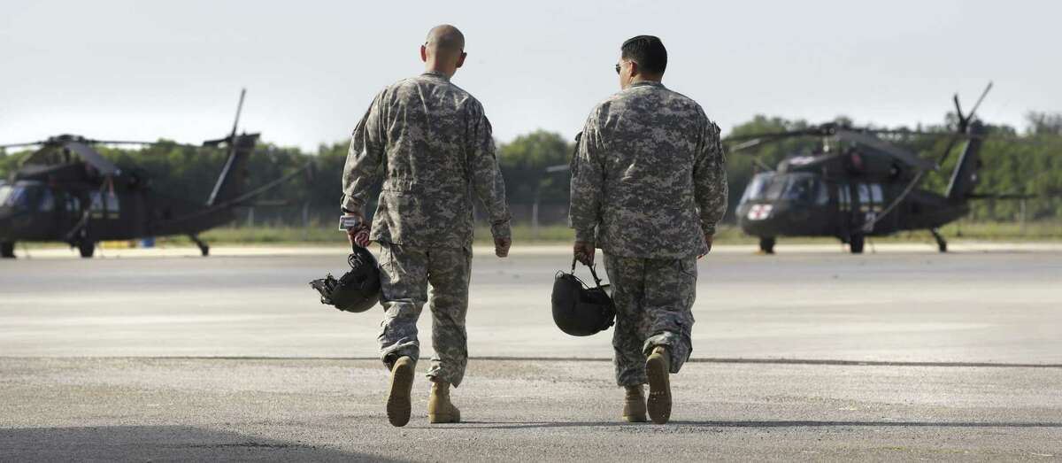 Black hawk pilots John Silva, left, and Tommy Loftis walk to an aircraft during the 2013 government shutdown at the Texas Air National Guard’s Martindale Army Airfield on the East Side. Another shutdown could occur Friday and would affect civilian workers at military posts and Guard activity such as routine maintenance and "run-ups" that evaluate engine and rotor systems on the ground.