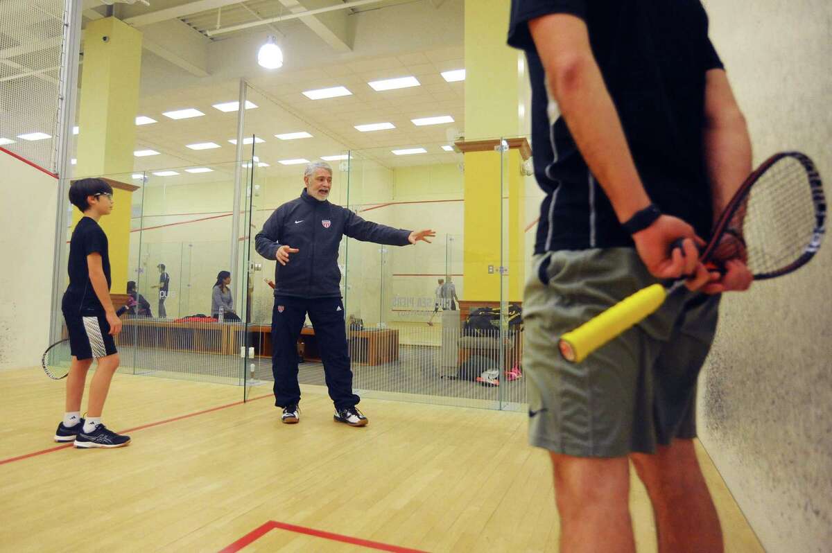 Paul Assaiante, the US Squash Head National Coach and the Men?’s and Women?’s Squash Coach at Trinity College, gives 12-year-old Marcus Ashcraft a pointer during his lesson inside Chelsea Piers on Blachley Road in Stamford, Conn. on Monday, Jan. 8, 2017.