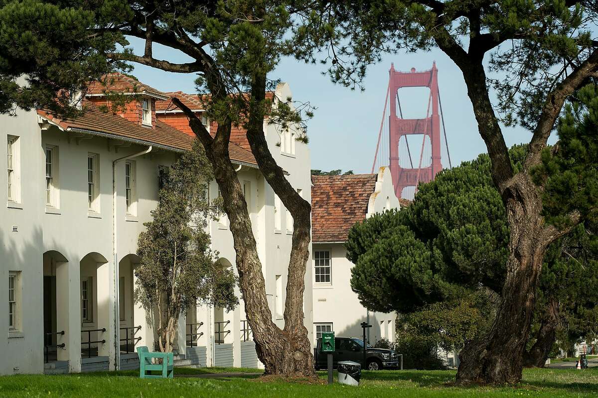The Golden Gate Bridge rises behind buildings at Fort Scott in the Presidio on Wednesday, Jan. 17, 2018, in San Francisco. The Presidio Trust hopes to find a developer to revitalize the area.