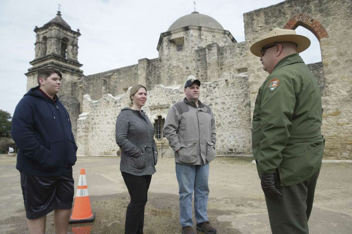 Visitors from Virginia listen to National Park Service Park Ranger Tom Castanos on the grounds of Mission San Jose on January 17, 2018. From left are Michael Elliott with mom and dad Jennifer Elliott and Fred Elliott.