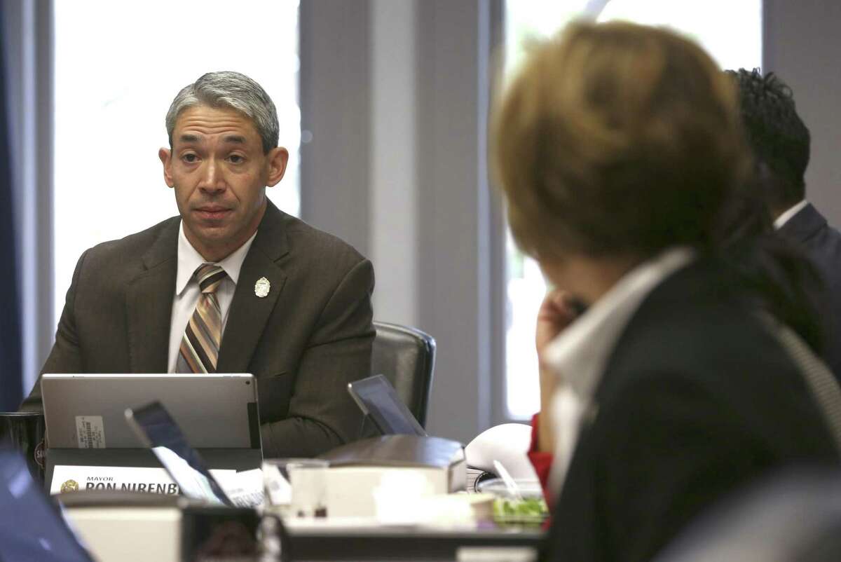 San Antonio Mayor Ron Nirenberg, left, listens during a recent meeting. He has proposed an independent research entity for the City Council; the council should make this happen.