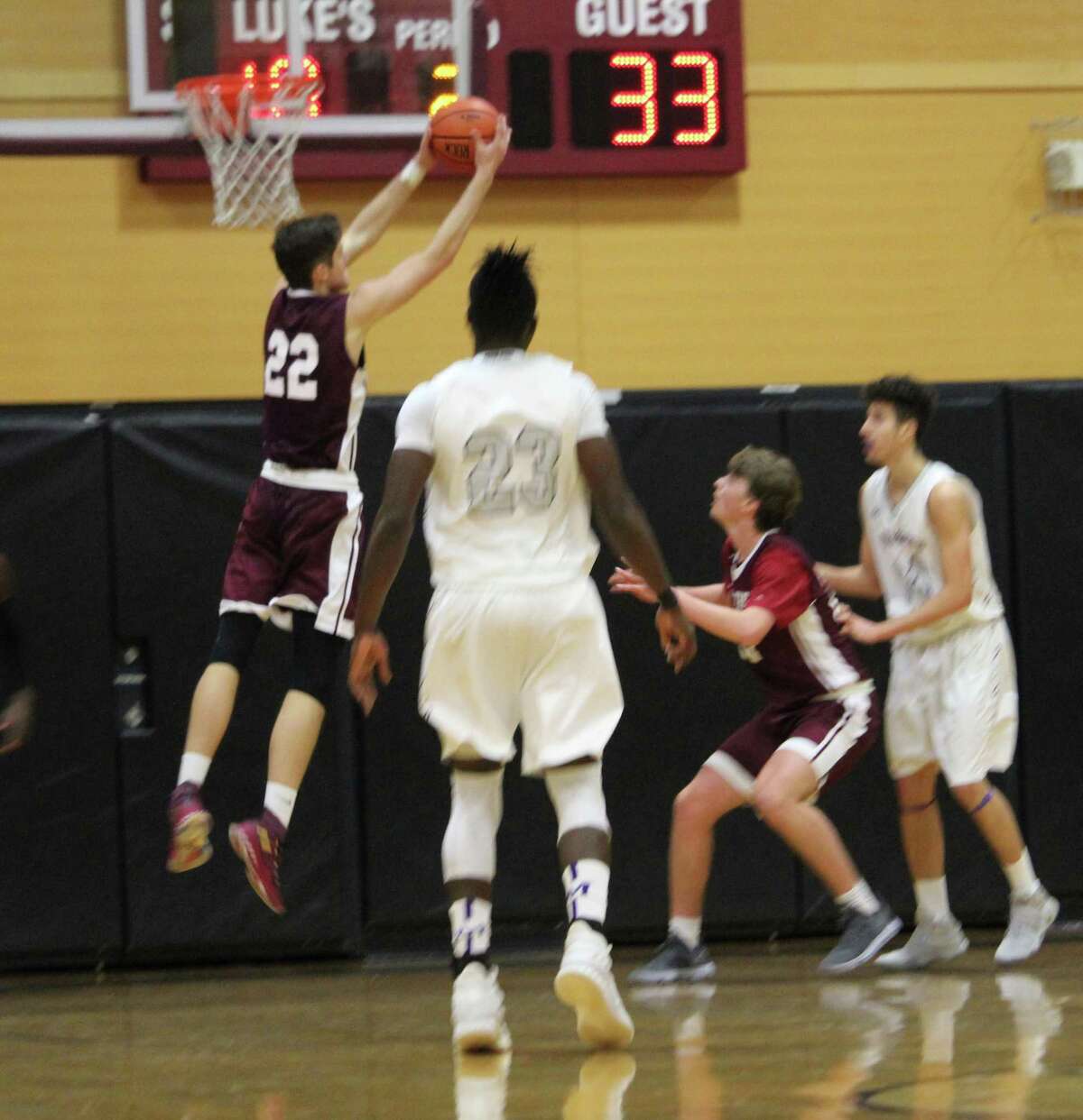 St. Luke's Scott Vollmer extends for a rebound during an FAA boys basketball game between St. Luke's and Masters (NY) at St. Luke's in New Canaan, Conn. St. Luke's defeated Masters 71-60.