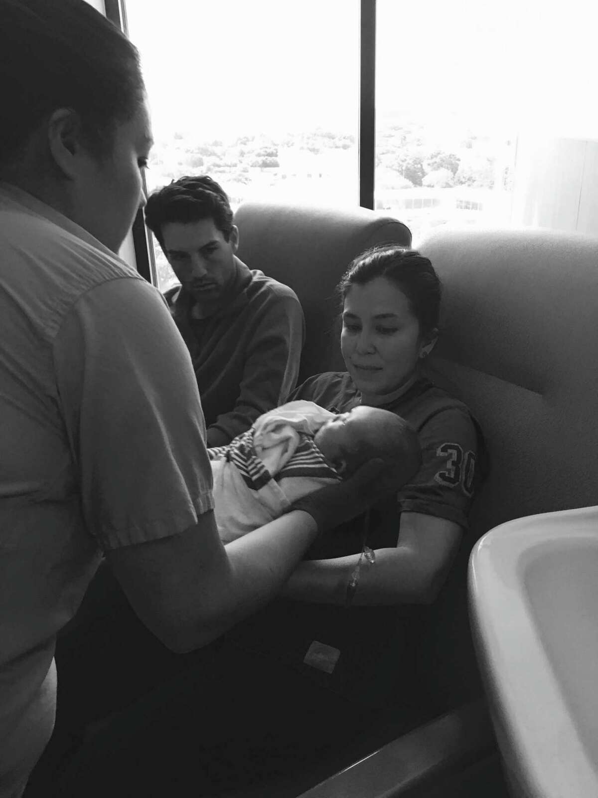 Vivian Graham holds her son, James, for the first time at North Central Baptist Hospital, as husband Braden Graham Sr. (center) looks on. James, who had a genetic mutation that prevented his limbs and chest from developing normally, died in her arms on Oct. 17, 2016, three days after his birth.