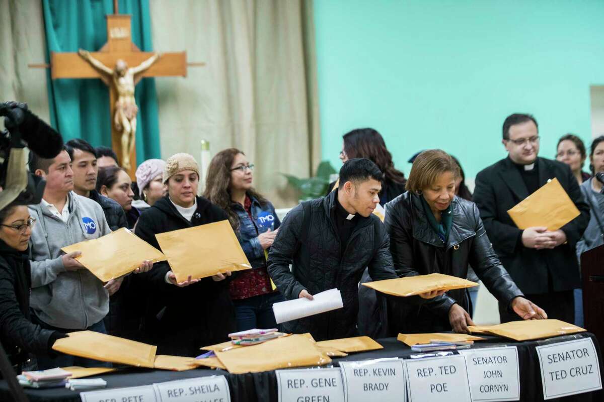 Father Vincenslaus Ino and Reverend Jacqueline Hailey handle the envelopes containing the postcards that are going to be sent to legislators asking them to support Deferred Action for Childhood Arrivals (DACA) and avoid separating families. Thursday, Jan. 18, 2018, in Houston. ( Marie D. De Jesus / Houston Chronicle )