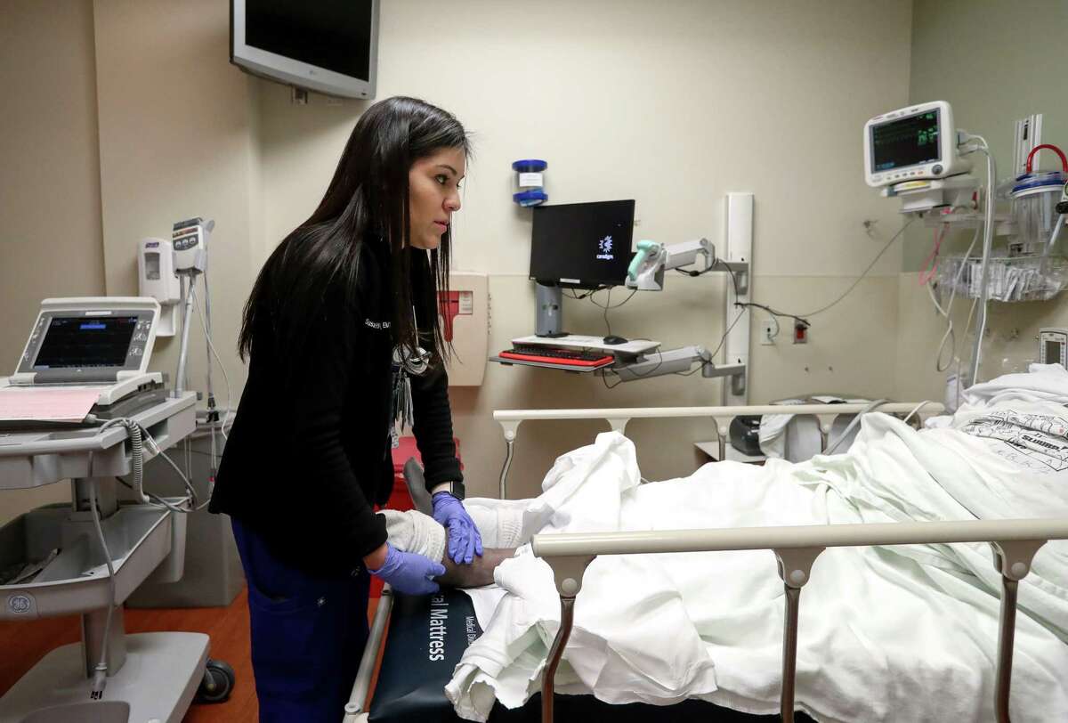 Susana Rosas, a DACA recipient and nurse, checks a patient at Methodist Sugar Land Hospital.﻿