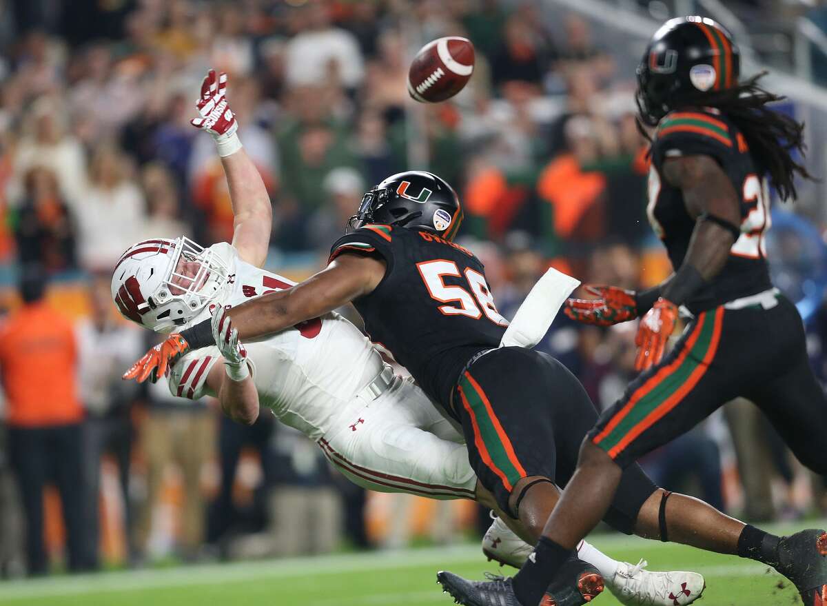 MIAMI GARDENS, FL - DECEMBER 30: Darrion Owens #58 of the Miami Hurricanes defends against Troy Fumagalli #81 of the Wisconsin Badgers during the 2017 Capital One Orange Bowl at Hard Rock Stadium on December 30, 2017 in Miami Gardens, Florida. Wisconsin defeated Miami 34-24. (Photo by Joel Auerbach/Getty Images)