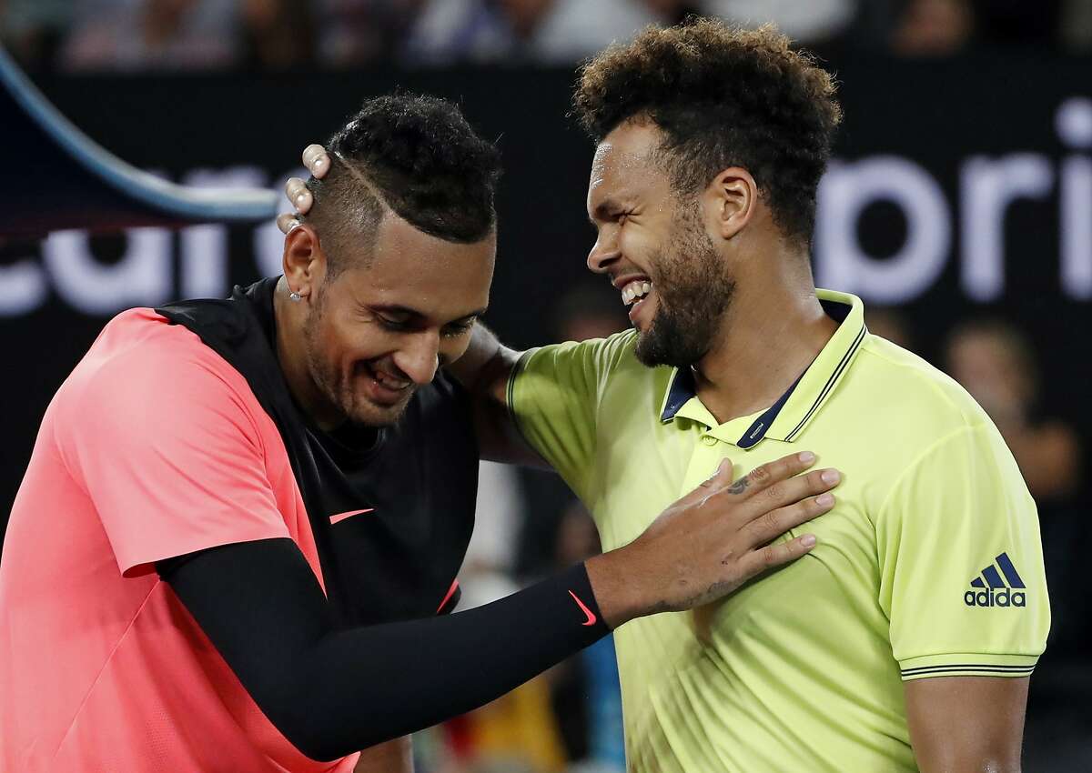 France's Jo-Wilfried Tsonga, right, congratulates Australia's Nick Kyrgios after Kyrgios won their third round match at the Australian Open tennis championships in Melbourne, Australia, Friday, Jan. 19, 2018. (AP Photo/Ng Han Guan)