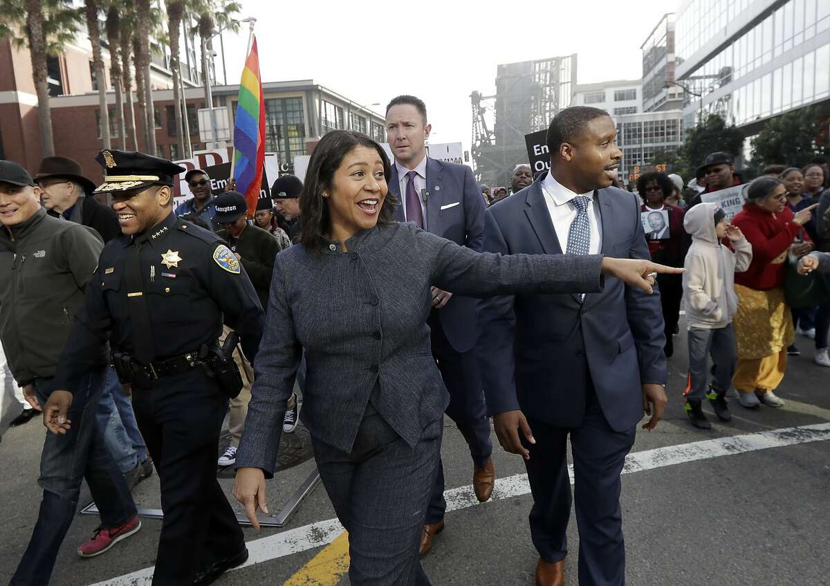 San Francisco acting Mayor London Breed, center, smiles during a march to mark the birthday of slain civil rights leader Martin Luther King Jr. in San Francisco, Monday, Jan. 15, 2018. (AP Photo/Jeff Chiu)
