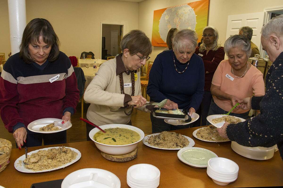 Attendees enjoy a family-style lunch featuring the dishes they helped make during class.