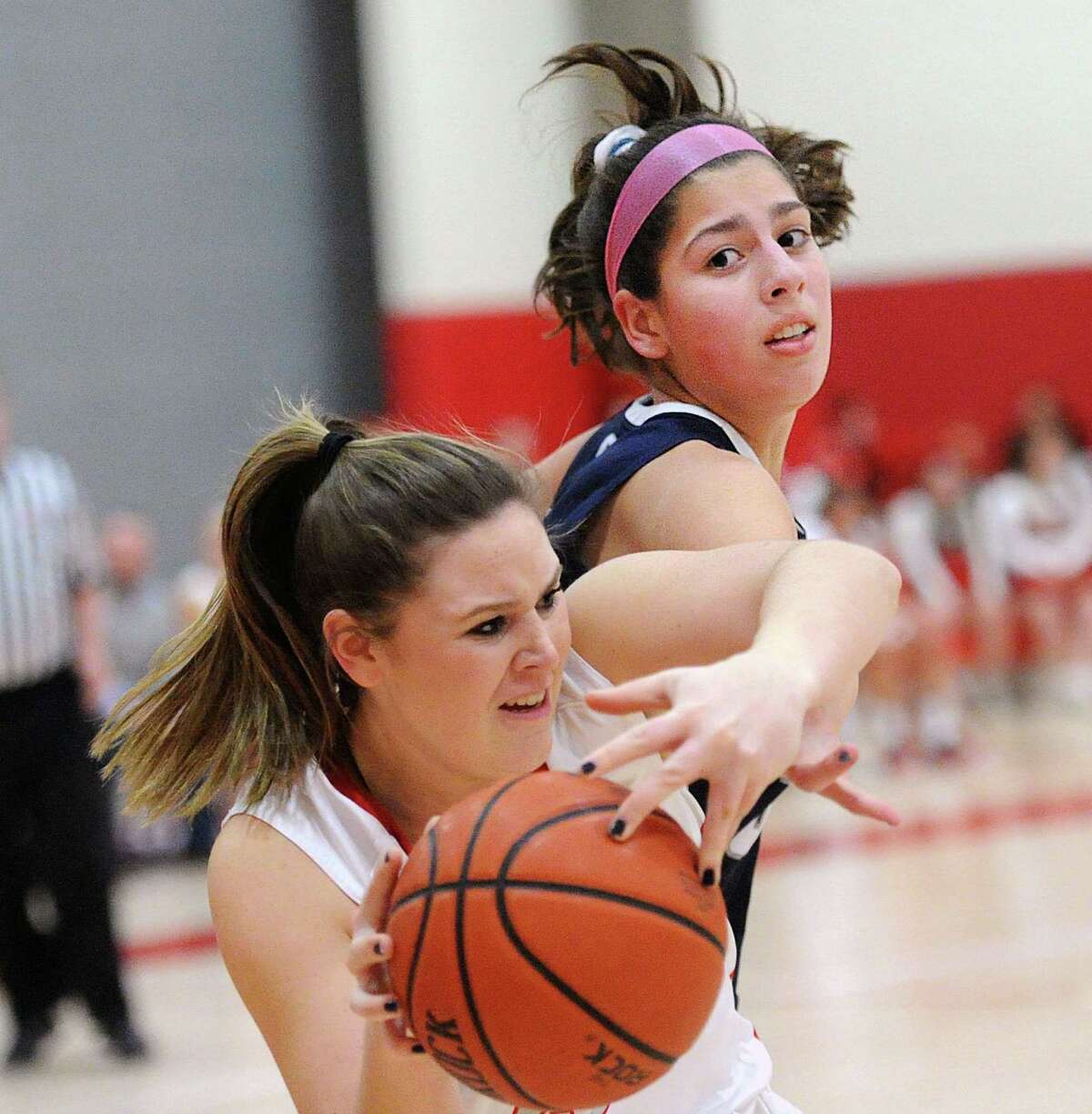 Arianna Gerig of Staples, top, attempts to steal the ball from Jordan Stefanowicz of Greenwich during the girls high school basketball game between Greenwich High School and Staples High School at Greenwich, Conn., Friday, Jan. 19, 2018.